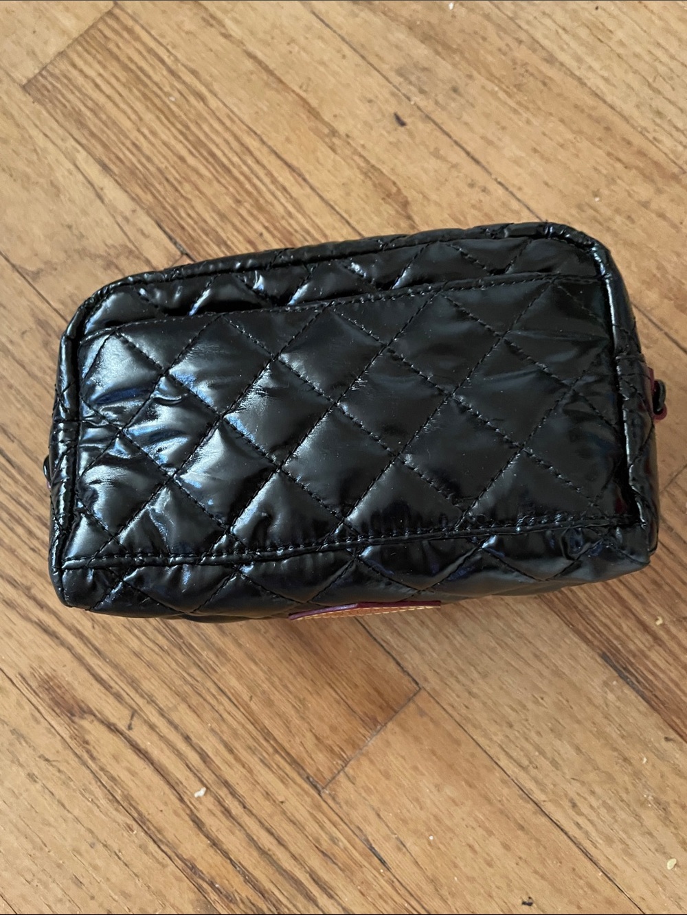 MZ Wallace Black Quilted Patent Wristlet with Orange Logo Patch